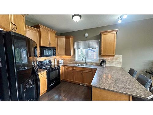 205 12Th Avenue Ne, Sundre, AB - Indoor Photo Showing Kitchen With Double Sink