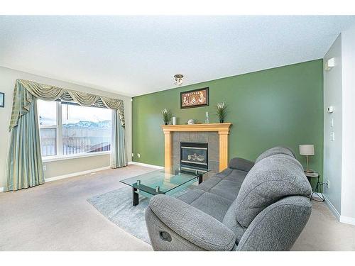 162 Saddlecrest Close Ne, Calgary, AB - Indoor Photo Showing Living Room With Fireplace