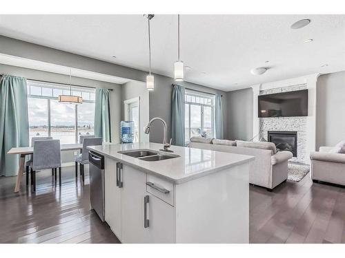 19 Lakewood Mews, Strathmore, AB - Indoor Photo Showing Kitchen With Fireplace With Double Sink With Upgraded Kitchen