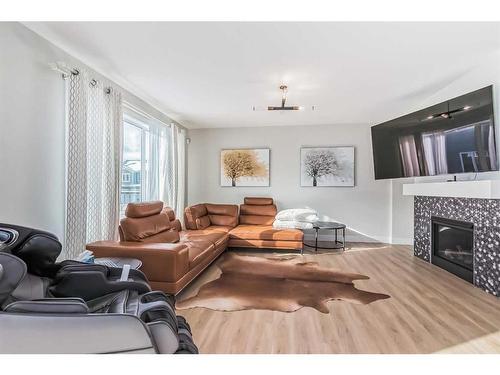 235 Carringham Road Nw, Calgary, AB - Indoor Photo Showing Living Room With Fireplace
