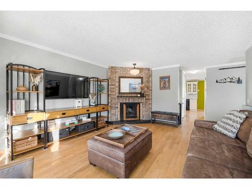 68 Stradwick Rise Sw, Calgary, AB - Indoor Photo Showing Living Room With Fireplace