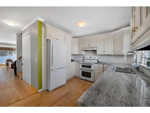 68 Stradwick Rise Sw, Calgary, AB - Indoor Photo Showing Kitchen With Double Sink