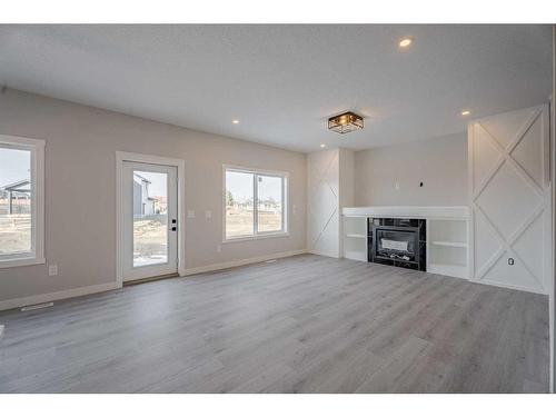 713 Mandalay Link, Carstairs, AB - Indoor Photo Showing Living Room With Fireplace