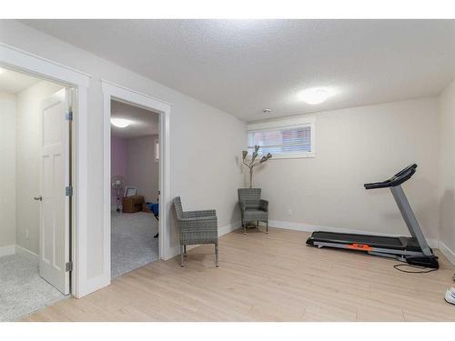 265 Kinniburgh Boulevard, Chestermere, AB - Indoor Photo Showing Gym Room