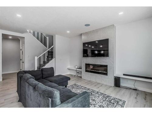 53 Belmont Villas Sw, Calgary, AB - Indoor Photo Showing Living Room With Fireplace