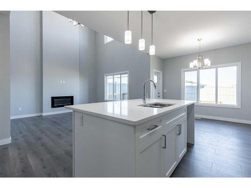 72 Key Cove, Airdrie, AB - Indoor Photo Showing Kitchen With Fireplace