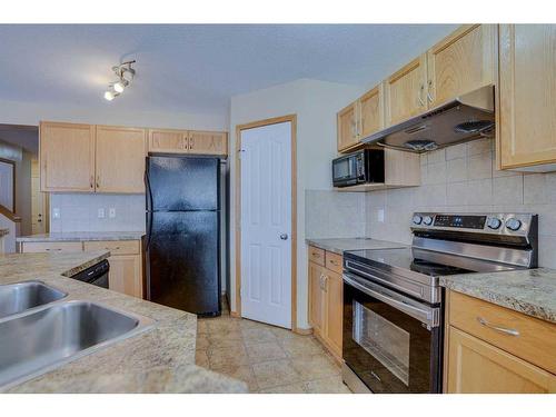 42 Saddlecrest Crescent Ne, Calgary, AB - Indoor Photo Showing Kitchen With Double Sink