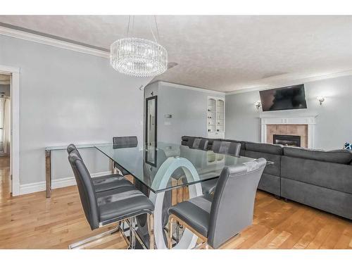 62 Kingston Drive, Red Deer, AB - Indoor Photo Showing Dining Room With Fireplace