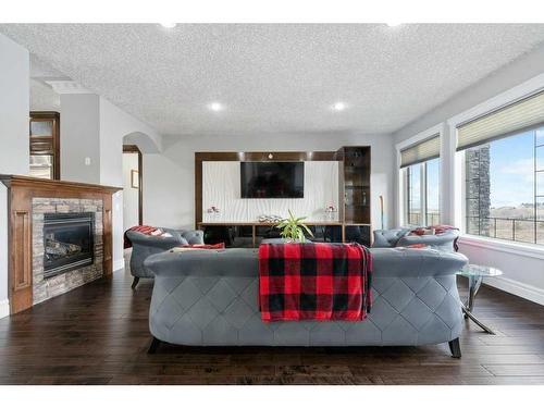 250040 Dynasty Drive West, Rural Foothills County, AB - Indoor Photo Showing Living Room With Fireplace