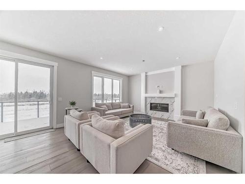 150 Sandpiper Park, Chestermere, AB - Indoor Photo Showing Living Room With Fireplace