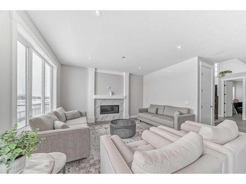 150 Sandpiper Park, Chestermere, AB - Indoor Photo Showing Living Room With Fireplace