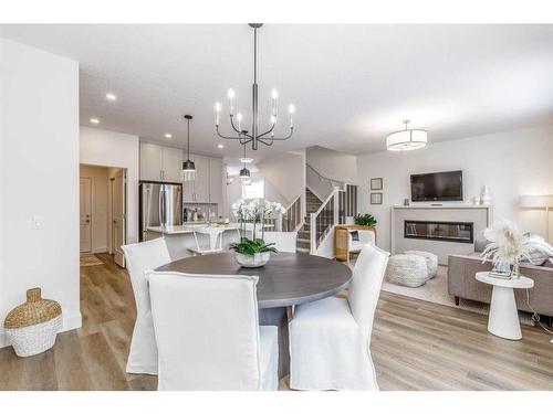 416 Rivercrest Road, Cochrane, AB - Indoor Photo Showing Dining Room With Fireplace