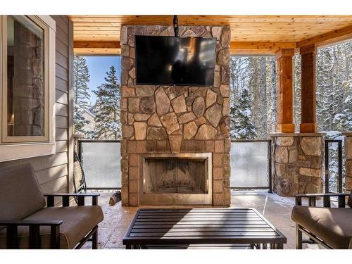 207 Hawk'S Landing Rise, Priddis Greens, AB - Indoor Photo Showing Living Room With Fireplace