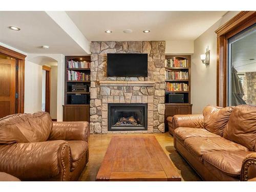207 Hawk'S Landing Rise, Priddis Greens, AB - Indoor Photo Showing Living Room With Fireplace