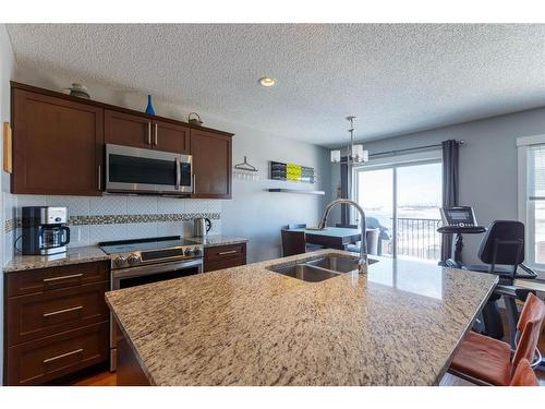 191 Sunrise View, Cochrane, AB - Indoor Photo Showing Kitchen With Double Sink