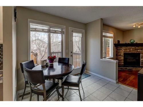 64 Valley Meadow Close Nw, Calgary, AB - Indoor Photo Showing Dining Room With Fireplace