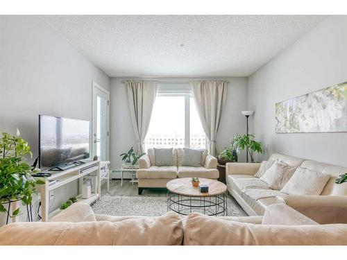 305-200 Shawnee Square Sw, Calgary, AB - Indoor Photo Showing Living Room