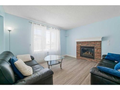 75 Saddlebrook Way Ne, Calgary, AB - Indoor Photo Showing Living Room With Fireplace
