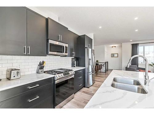 195 Riverwood Crescent, Diamond Valley, AB - Indoor Photo Showing Kitchen With Double Sink With Upgraded Kitchen