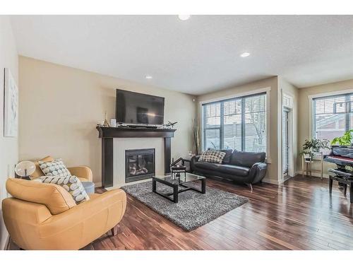 128 Mike Ralph Way Sw, Calgary, AB - Indoor Photo Showing Living Room With Fireplace