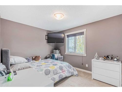 128 Mike Ralph Way Sw, Calgary, AB - Indoor Photo Showing Bedroom