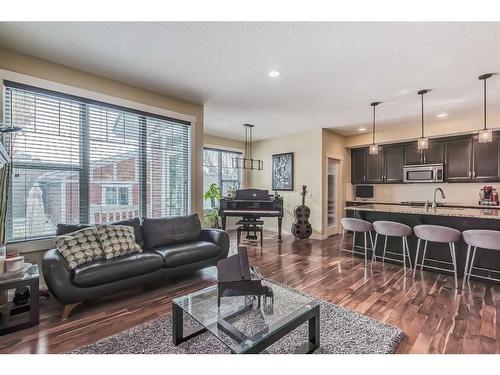 128 Mike Ralph Way Sw, Calgary, AB - Indoor Photo Showing Living Room