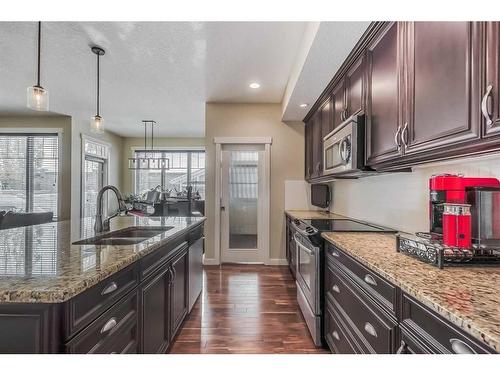 128 Mike Ralph Way Sw, Calgary, AB - Indoor Photo Showing Kitchen With Double Sink