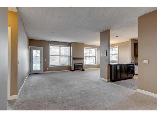 106-88 Arbour Lake Road Nw, Calgary, AB - Indoor With Fireplace