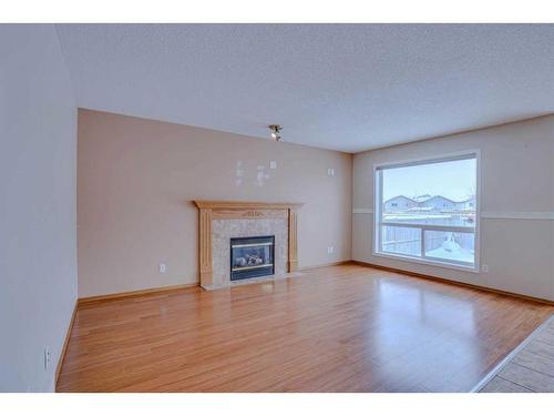 71 Taracove Crescent Ne, Calgary, AB - Indoor Photo Showing Living Room With Fireplace