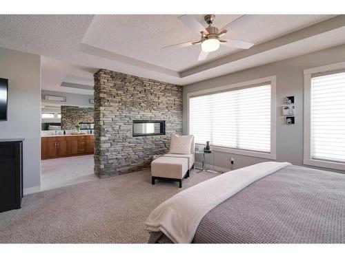 361 Auburn Shores Landing Se, Calgary, AB - Indoor Photo Showing Bedroom With Fireplace