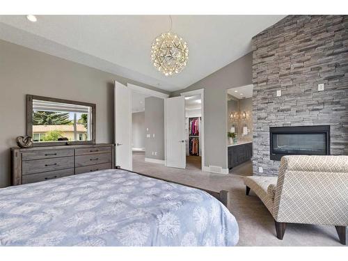 3332 Barrett Place Nw, Calgary, AB - Indoor Photo Showing Bedroom With Fireplace
