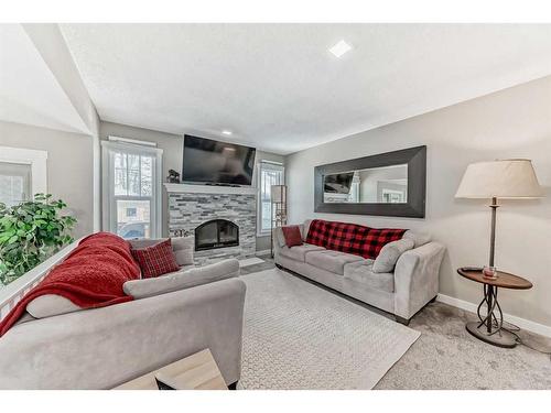 440 Cantrell Drive Sw, Calgary, AB - Indoor Photo Showing Living Room With Fireplace