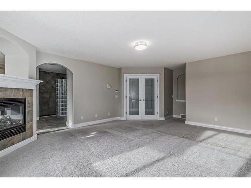 142 Panatella Circle Nw, Calgary, AB - Indoor Photo Showing Other Room With Fireplace