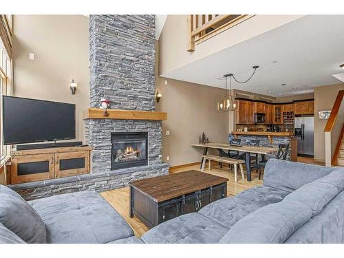 201-75 Dyrgas Gate, Canmore, AB - Indoor Photo Showing Living Room With Fireplace