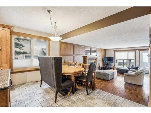 44 Shawnee Way Sw, Calgary, AB - Indoor Photo Showing Dining Room With Fireplace