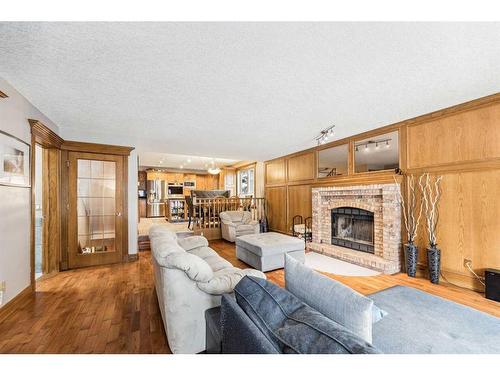 44 Shawnee Way Sw, Calgary, AB - Indoor Photo Showing Living Room With Fireplace