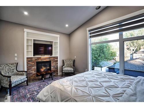 1025 2 Avenue Nw, Calgary, AB - Indoor Photo Showing Bedroom With Fireplace