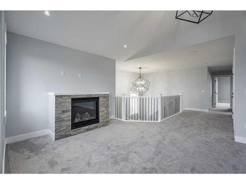 1439 Scarlett Ranch Boulevard, Carstairs, AB - Indoor Photo Showing Living Room With Fireplace