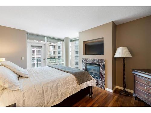 505-837 2 Avenue Sw, Calgary, AB - Indoor Photo Showing Bedroom With Fireplace