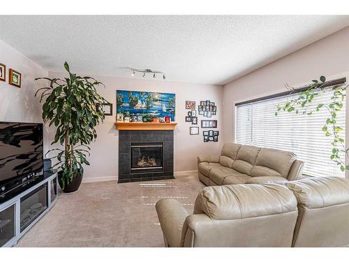 344 Windermere Drive, Chestermere, AB - Indoor Photo Showing Living Room With Fireplace