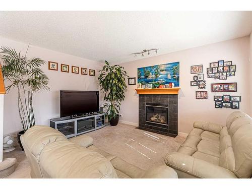 344 Windermere Drive, Chestermere, AB - Indoor Photo Showing Living Room With Fireplace