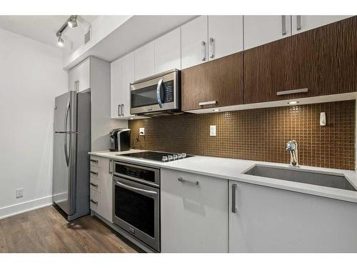 120-619 Confluence Way Se, Calgary, AB - Indoor Photo Showing Kitchen With Stainless Steel Kitchen With Upgraded Kitchen