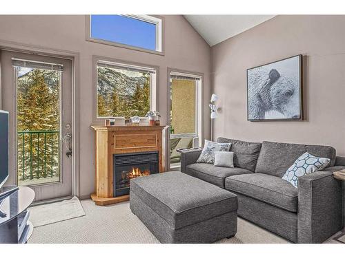 319-176 Kananaskis Way, Canmore, AB - Indoor Photo Showing Living Room With Fireplace