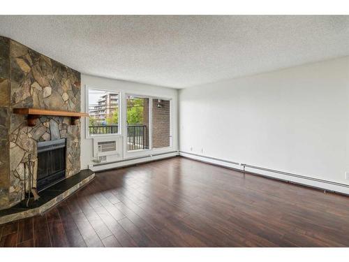 506-333 2 Avenue Ne, Calgary, AB - Indoor Photo Showing Living Room With Fireplace