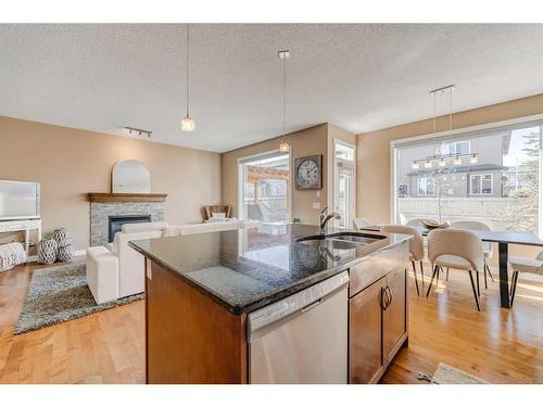 496 Everbrook Way Sw, Calgary, AB - Indoor Photo Showing Kitchen With Fireplace With Double Sink