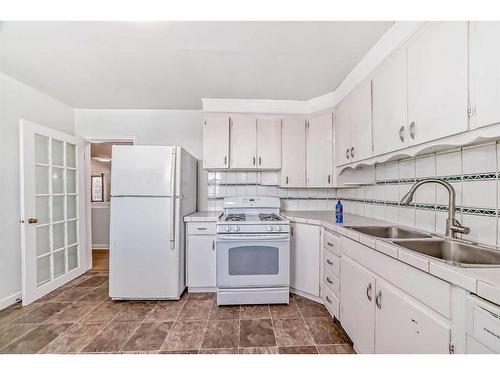 1910 Alexander Street Se, Calgary, AB - Indoor Photo Showing Kitchen With Double Sink