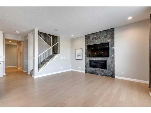 419 Rivercrest Boulevard, Cochrane, AB - Indoor Photo Showing Living Room With Fireplace