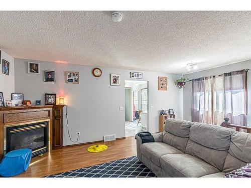 50 Tararidge Drive Ne, Calgary, AB - Indoor Photo Showing Living Room With Fireplace