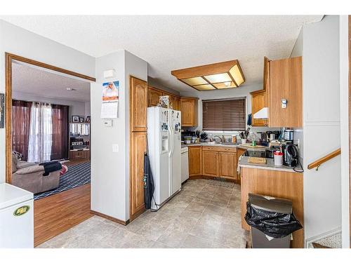 50 Tararidge Drive Ne, Calgary, AB - Indoor Photo Showing Kitchen With Double Sink