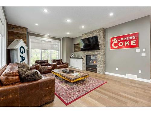211 Hawk'S Landing Rise, Priddis Greens, AB - Indoor Photo Showing Living Room With Fireplace